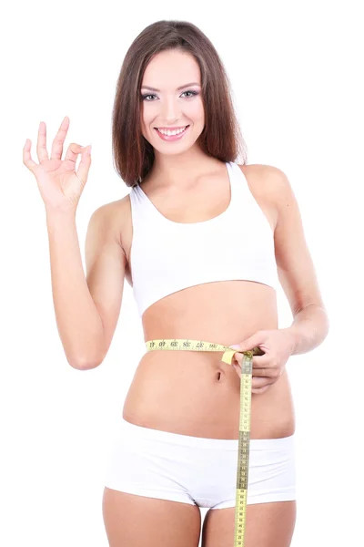 美しい若い女性白で隔離テープで彼女の体を測定 ストックフォト