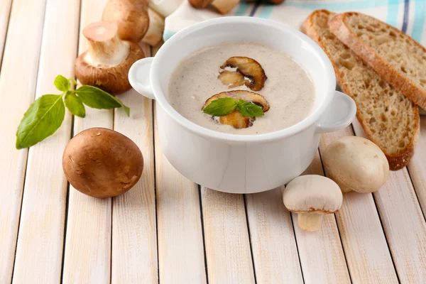 Mushroom soup in white pot, on napkin, on wooden background — Stock Image Mushroom soup in white pot, on napkin, on wooden background Royalty Free Stock Images