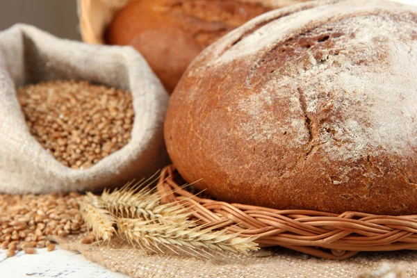 Rye bread with grains on sackcloth on table close up — Stock Photo, Image