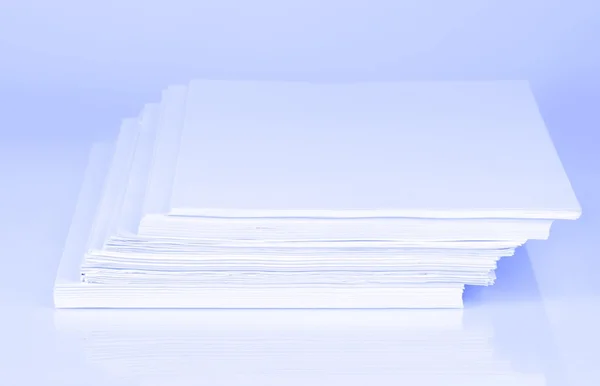 Stack white paper in blue light — Stock Photo, Image