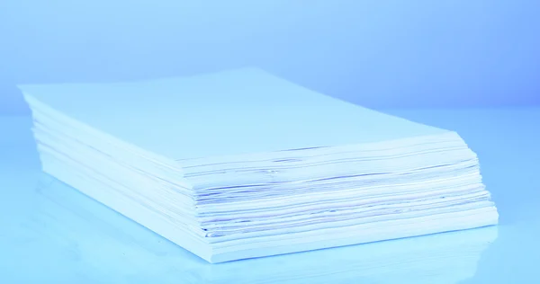 Stack white paper in blue light — Stock Photo, Image