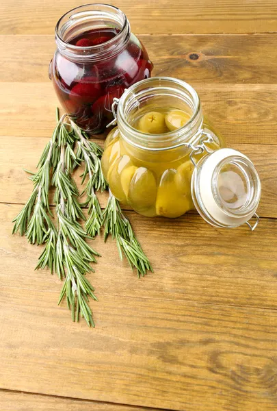 Olive saporite su tavola di legno, su sfondo naturale — Foto Stock