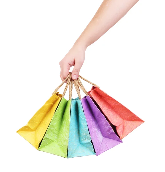 Borse shopping colorate in mano femminile, isolate su bianco — Foto Stock