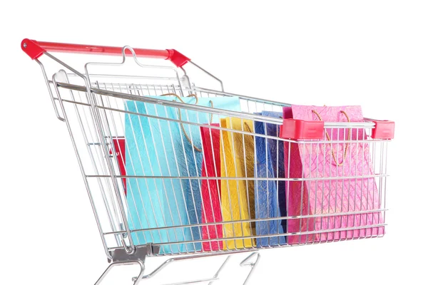 Colorful shopping bags in shopping trolley, isolated on white — Stock Photo, Image