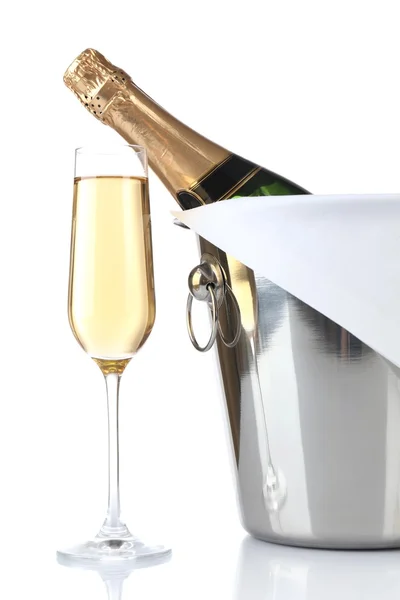 Glass of champagne and bottle in pail, isolated on white — Stock Photo, Image