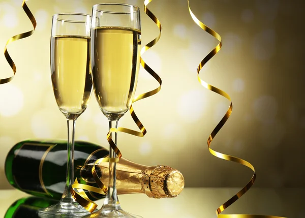 Glasses and bottle of champagne on light background — Stock Photo, Image