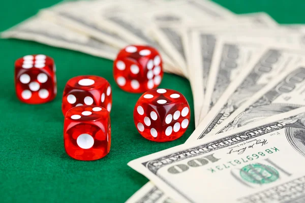 Red dices and dollars on green background — Stock Photo, Image