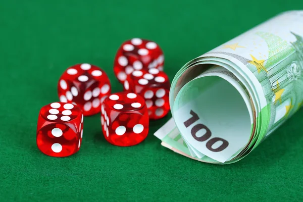 Red dices and money, on green background — Stock Photo, Image