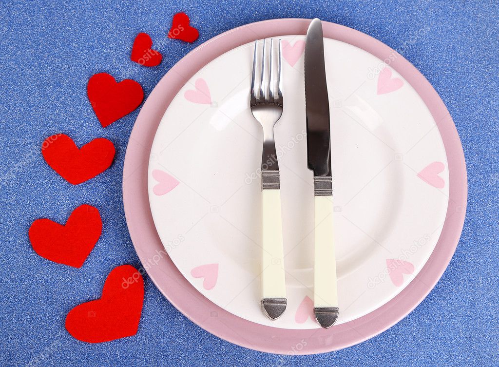 Valentines day dinner with table setting on blue background