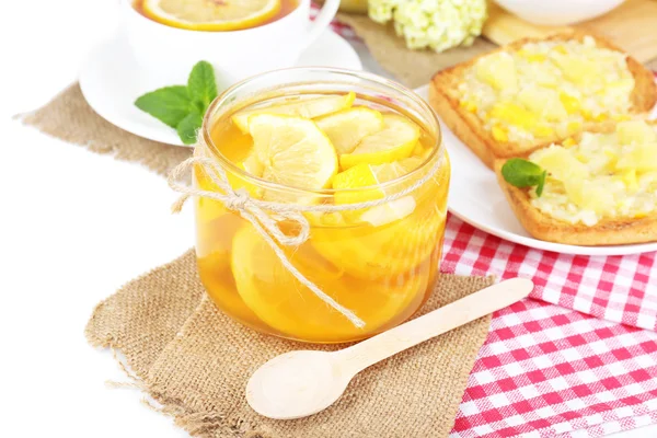 Tasty lemon jam with cup of tea on table close-up — Stock Photo, Image