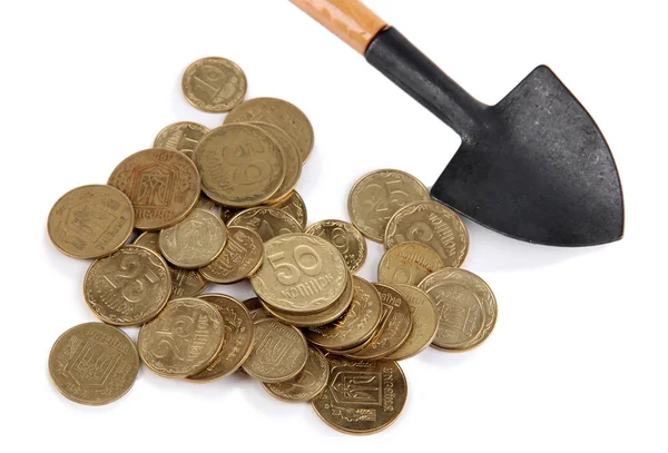 Coins with shovel isolated on white — Stock Photo, Image