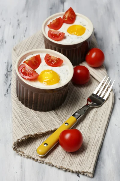 Baked eggs on wooden table close up — Stock Photo, Image