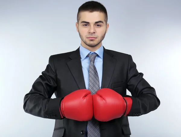 Business man on grey background — Stock Photo, Image