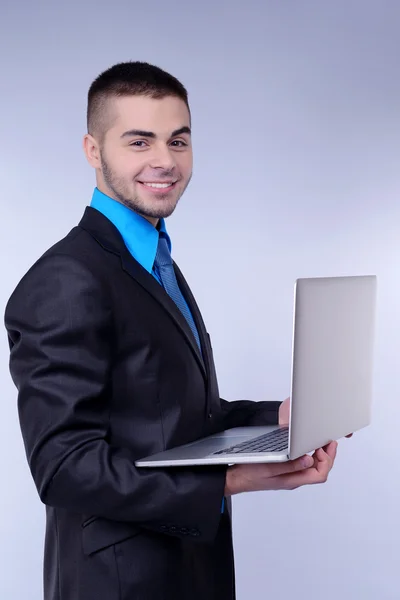 Business man on grey background — Stock Photo, Image