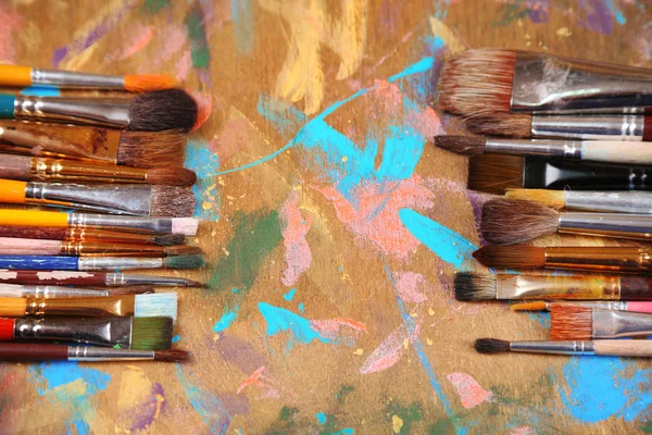 Brushes on multicolor  wooden background — Stock Photo, Image