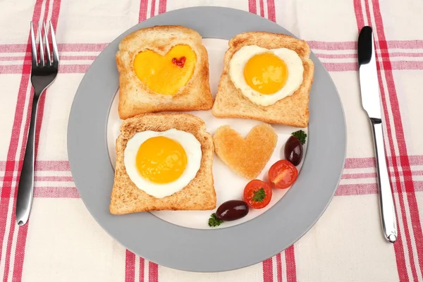 Яєчня з хлібом на тарілці, на кольоровій серветці — стокове фото