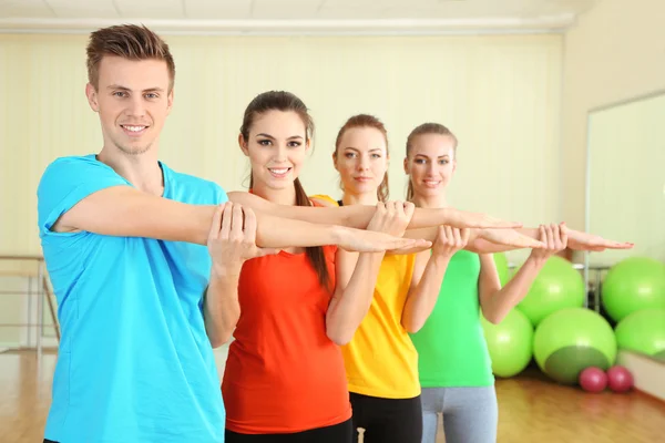 Young beautiful peoples engaged in gym Royalty Free Stock Images