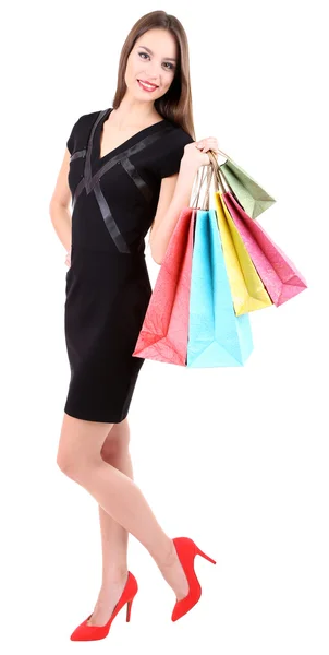 Beautiful young woman holding shopping bags isolated on white — Stock Photo, Image