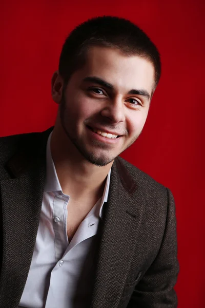 Handsome young on red background — Stock Photo, Image