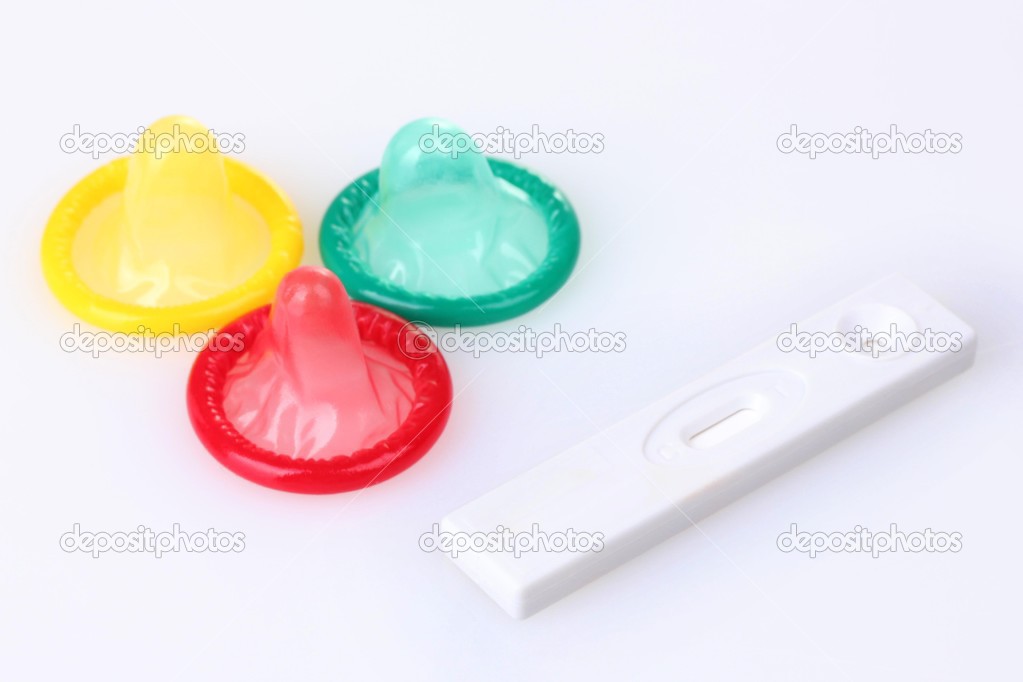 birth condoms and pregnancy test isolated on white