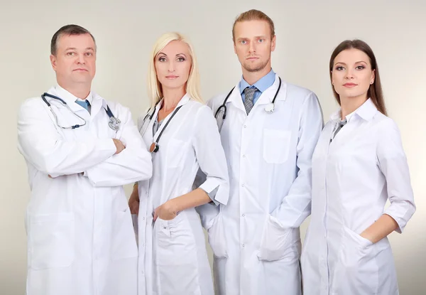 Medical workers on grey background — Stock Photo, Image