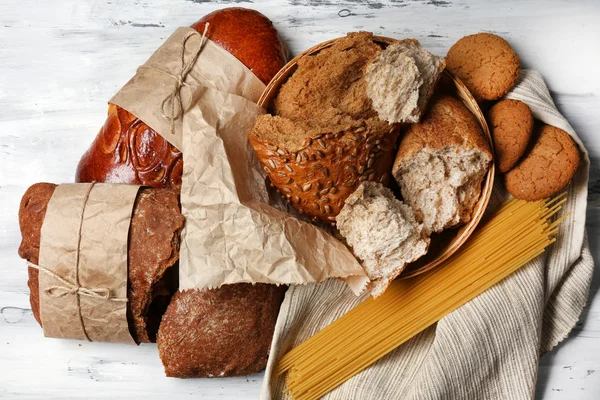 Breaking bread on wooden table — Stock Photo, Image