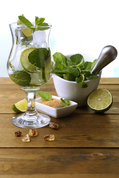 Ingredients for lemonade on wooden table, on nature background — Stock Photo, Image