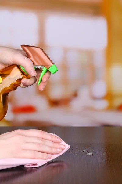 Hand cleaning wooden table with furniture polish — Stock Photo, Image