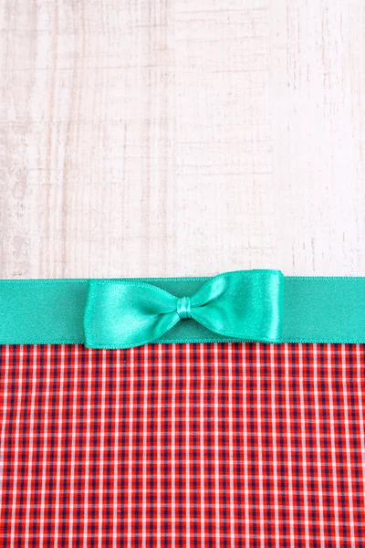Colorful fabric with color ribbon and bow on wooden background — Stock Photo, Image