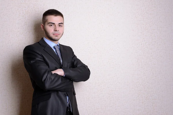 Portrait of businessman near wall — Stock Photo, Image