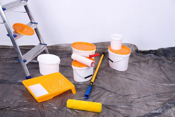 Eimer mit Farbe und Leiter auf Wandhintergrund. Konzeptionelles Foto von Reparaturarbeiten im Raum — Stockfoto