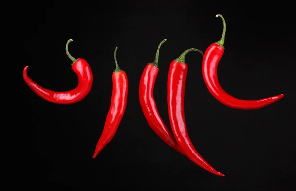 Red hot chili peppers isolated on black — Stock Photo, Image