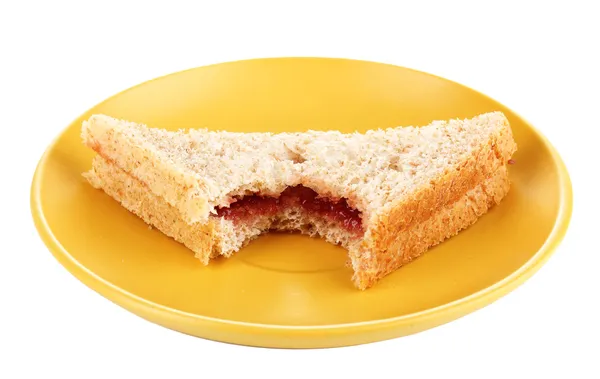 Sanduíche mordido com geléia na placa isolada em branco — Fotografia de Stock