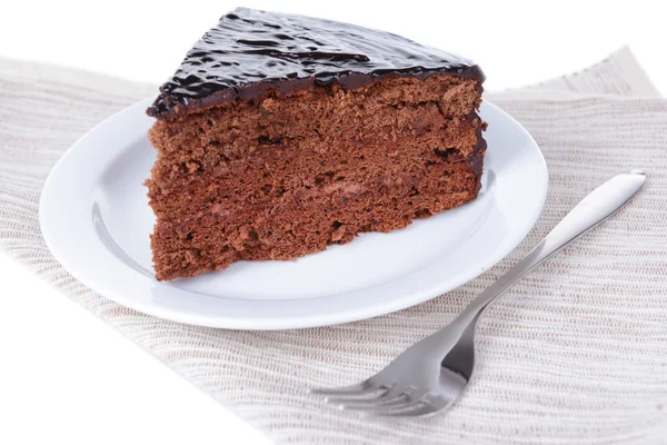 Delicious chocolate cake on plate on table close-up — Stock Photo, Image