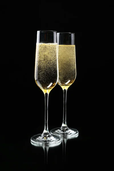 Glasses of champagne, on black background — Stock Photo, Image