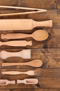Wooden kitchen utensils on table close-up clipart