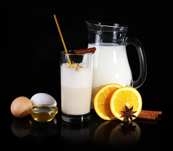 Eggnog with milk and eggs on black background — Stock Photo, Image