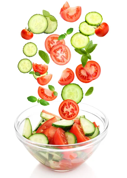 Fresh mixed vegetables falling into bowl of salad isolated on white — Stock Photo, Image