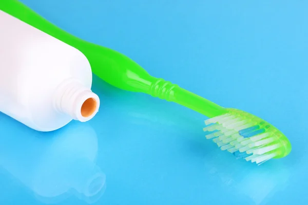 Toothbrush and paste on blue background — Stock Photo, Image