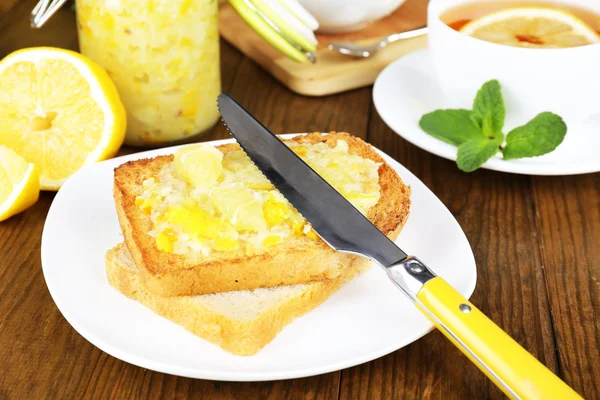 Deliciosas torradas com geléia de limão na placa na mesa close-up — Fotografia de Stock