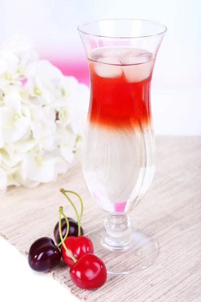 Glass of cocktail on table on light background — Stock Photo, Image