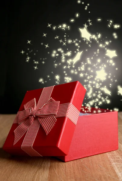 Open gift box on dark background — Stock Photo, Image