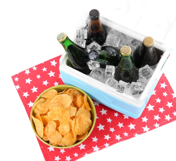 Ice chest full of drinks in bottles on color napkin, isolated on white — Stock Photo, Image