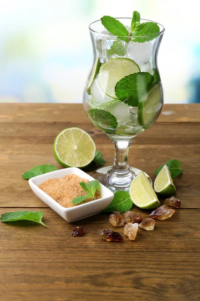 Ingredients for lemonade in glass, on wooden table, on nature background — Stock Photo, Image