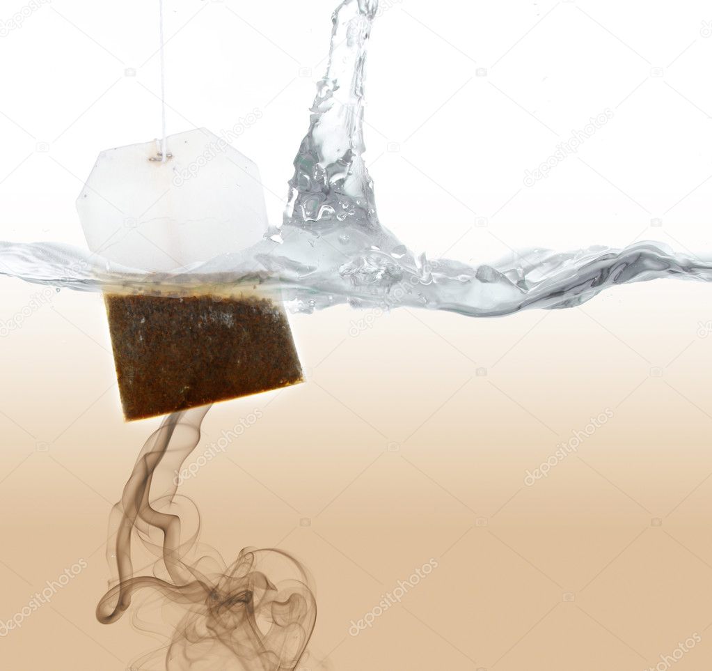Tea bag dipped in hot water