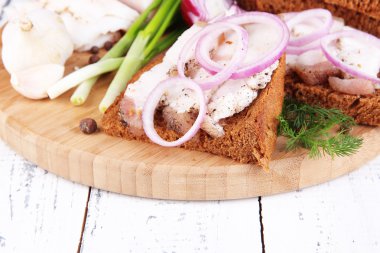 dilim ekmek ve domuz yağı ile soğan ahşap zemin üzerinde kesme tahtası üzerinde