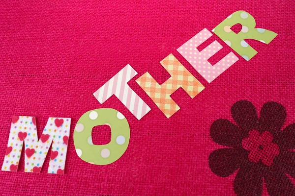 Mamma-bokstäver av handgjort papper bokstäver på rosa bakgrund — Stockfoto