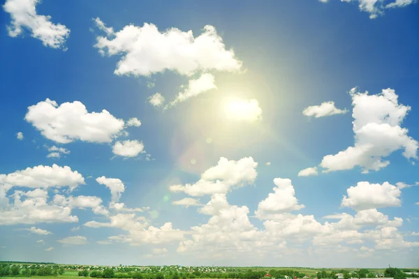 Blue sky with clouds and sun — Stock Photo, Image