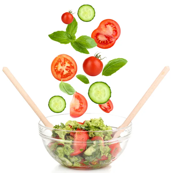 Fresh mixed vegetables falling into bowl of salad isolated on white — Stock Photo, Image