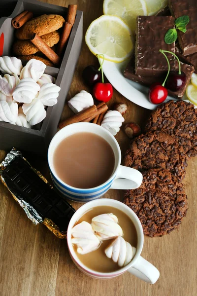 Cup of cappuccino and sweets close up — Stock Photo, Image